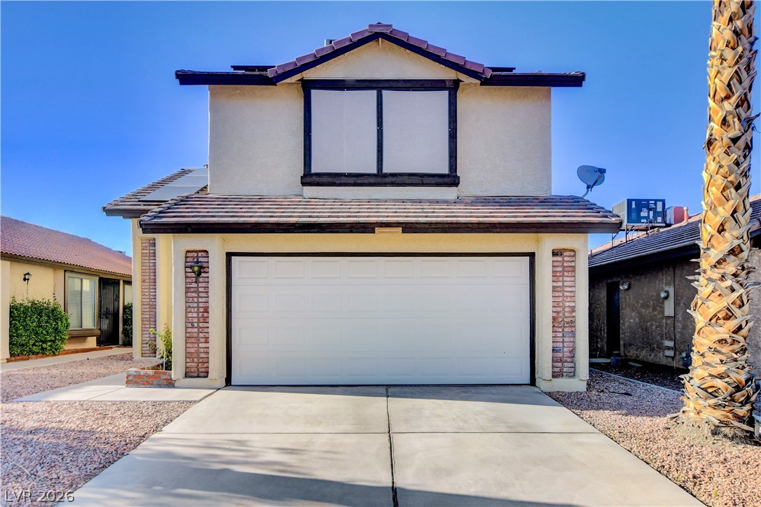 6440 Hartwood Road Las Vegas, NV 89108 - Photo 1 of 59 A classic two-story residence with a garage and a tiled roof, offering convenient front-facing parking.
