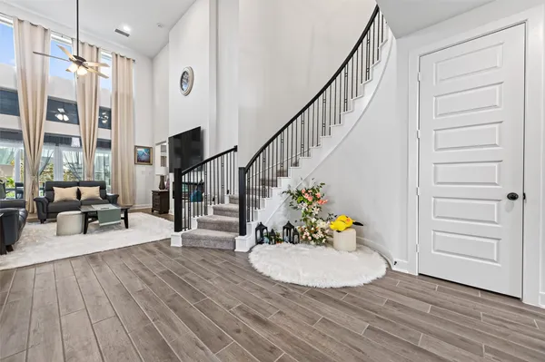 a view of a livingroom with wooden floor and furniture