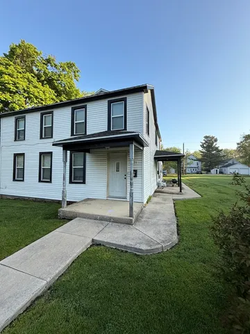 a view of an house with backyard space and garden