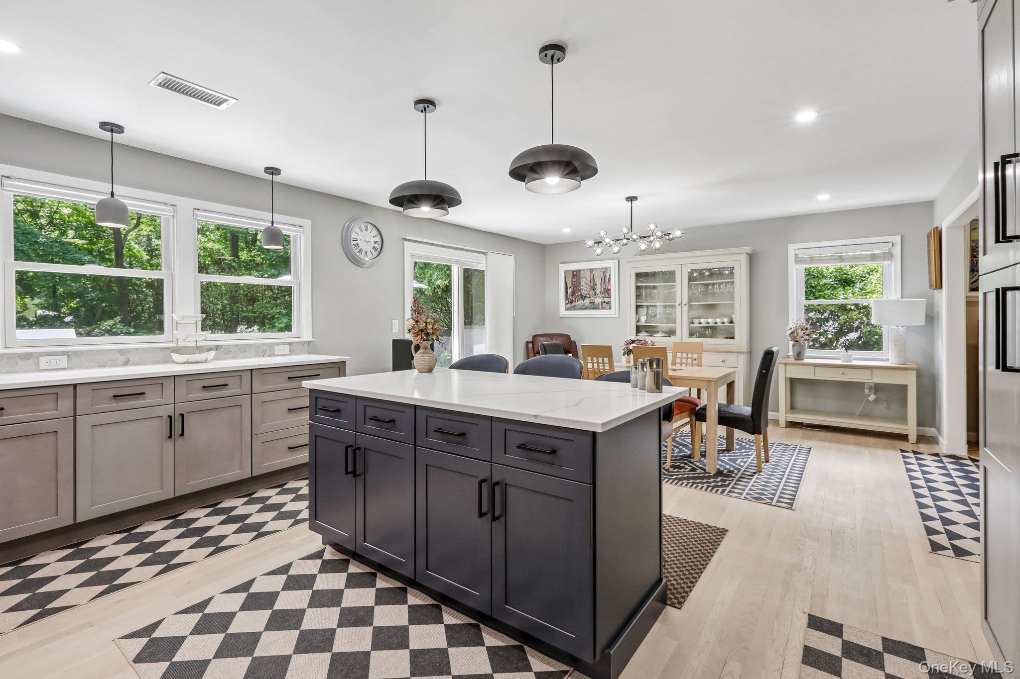 62 Mohegan Road Larchmont, NY 10538 - Photo 29 of 46 a kitchen with stainless steel appliances granite countertop a stove a sink a dining table and chairs with wooden floor
