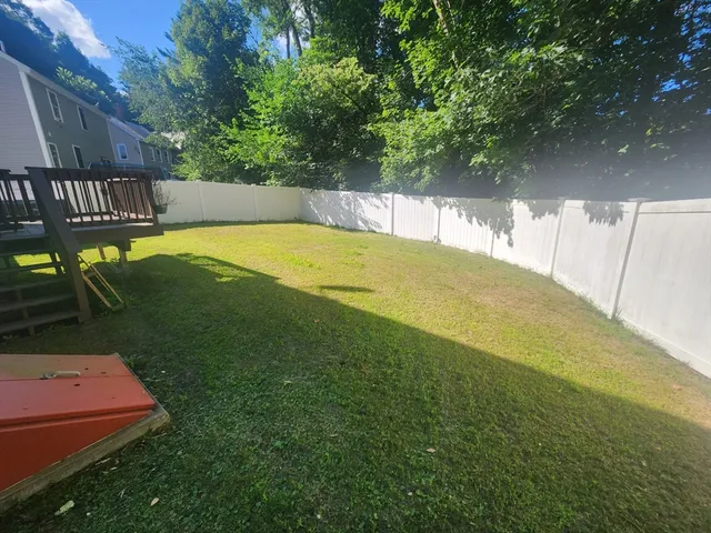 a view of a swimming pool with a bench and trees