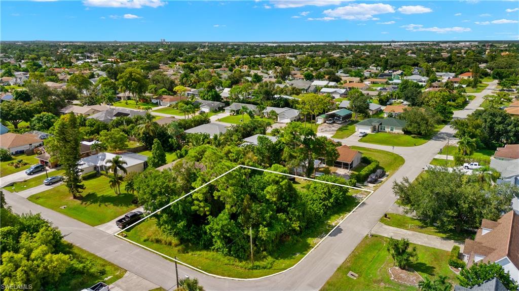 9167 Morris Road Fort Myers, FL 33967 - Photo 1 of 21 an aerial view of residential houses with outdoor space and trees