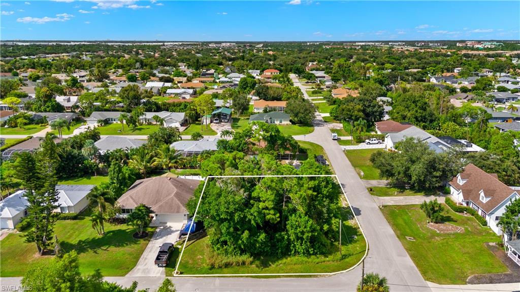 9167 Morris Road Fort Myers, FL 33967 - Photo 2 of 21 an aerial view of residential houses with outdoor space and trees