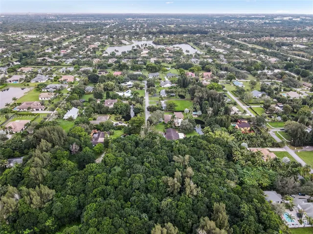 an aerial view of residential houses with city view