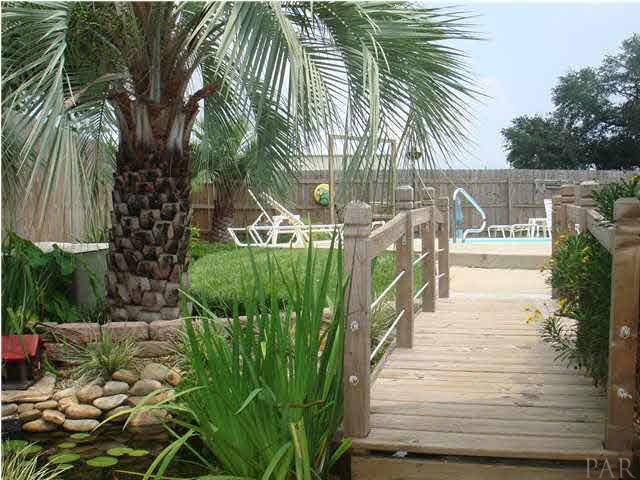 600 Copper Ridge Drive Cantonment, FL 32533 - Photo 16 of 22 New landscaping includes bridge over koi pond.