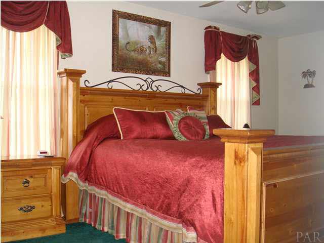 600 Copper Ridge Drive Cantonment, FL 32533 - Photo 22 of 22 Master bedroom is split floorplan, french door here exits to Florida room.