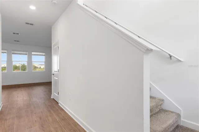 a view of an entryway with wooden floor