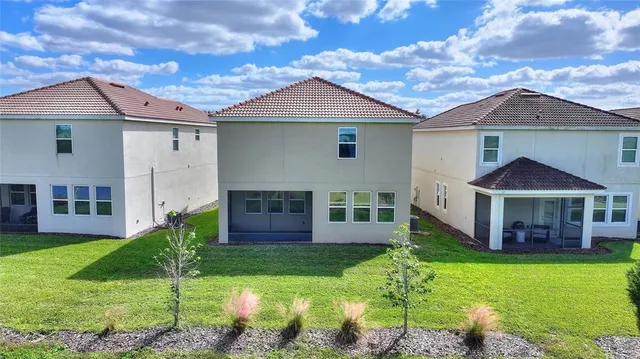 an aerial view of a house with a swimming pool yard and outdoor seating