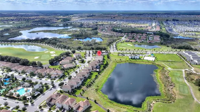 an aerial view of a house with a yard