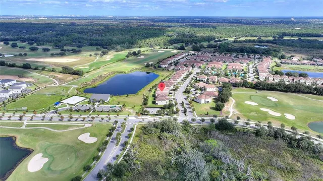 a view of a hallway with wooden floor and a bathroom