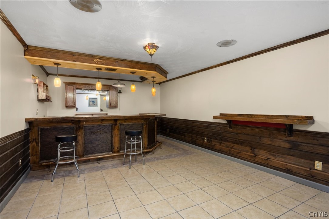 1322 Sawmill Road Sangerfield, NY 13480 - Photo 38 of 50 A spacious home bar area features tile flooring and detailed wood wainscoting.