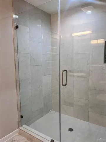 a bathroom with a shower and a sink