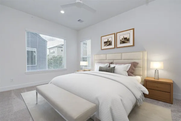 a spacious bedroom with a bed and a window