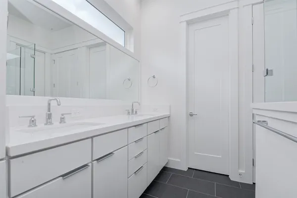 a bathroom with a double vanity sink and a mirror