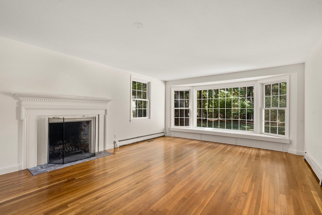 13 Wood Road Sherborn, MA 01770 - Photo 14 of 38 a view of an empty room with wooden floor and a window
