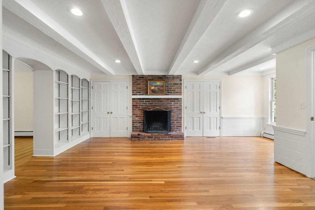 13 Wood Road Sherborn, MA 01770 - Photo 19 of 38 a view of an empty room with a fireplace and a window