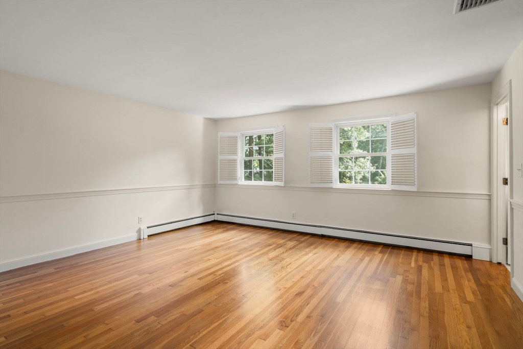 13 Wood Road Sherborn, MA 01770 - Photo 28 of 38 an empty room with wooden floor and windows