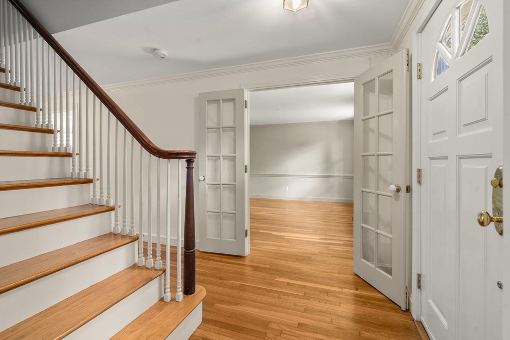 13 Wood Road Sherborn, MA 01770 - Photo 5 of 38 a view of entryway with wooden floor and staircase