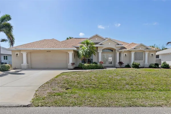 a front view of a house with a yard and garage