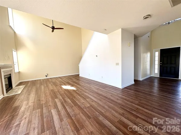 wooden floor in an empty room with a fireplace