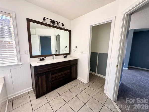 a bathroom with a sink a mirror and a vanity