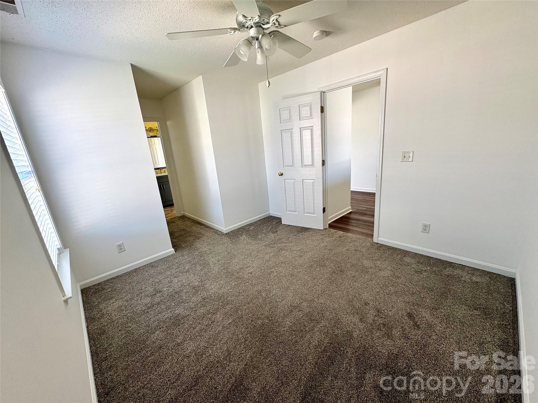 89 Woodfern Road Fletcher, NC 28732 - Photo 10 of 19 an empty room with windows and fan