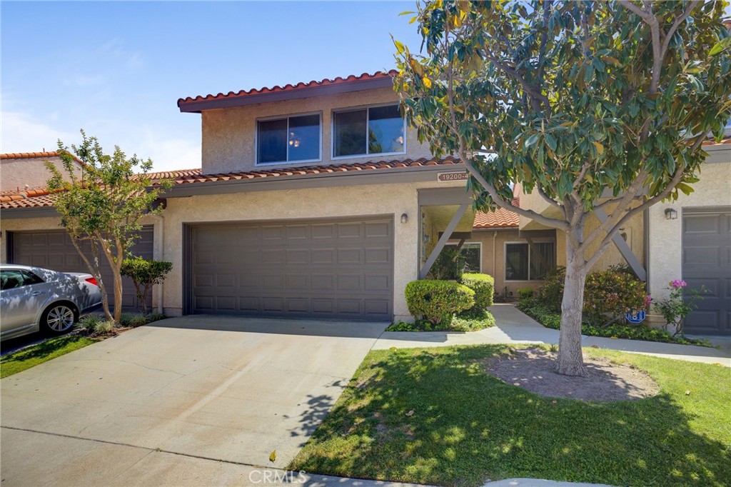 19200 Index Street, Unit 4 Porter Ranch, CA 91326 - Photo 1 of 1 a front view of a house with a yard and garage