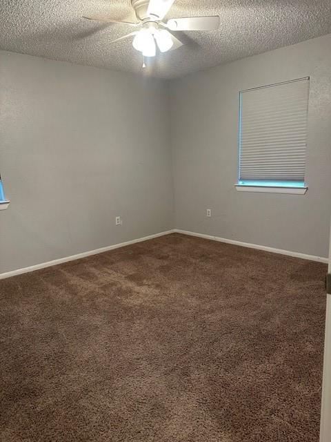 209 School Street Blue Ridge, TX 75424 - Photo 6 of 9 an empty room with a chandelier fan and windows