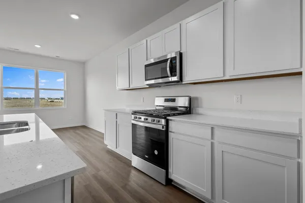 a kitchen with stainless steel appliances a sink stove and cabinets