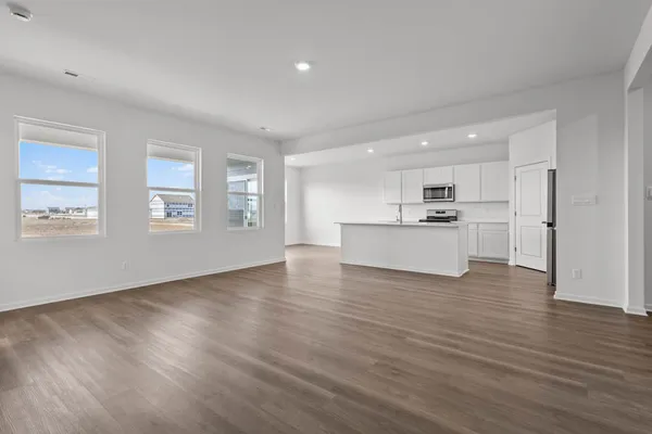 a view of kitchen with wooden floor and electronic appliances
