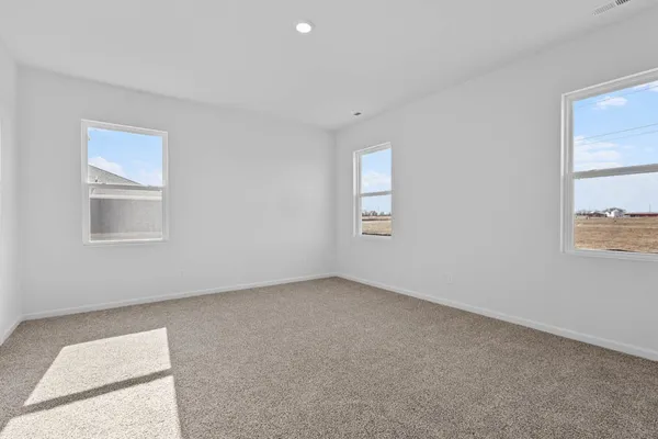 a view of an empty room and closet area