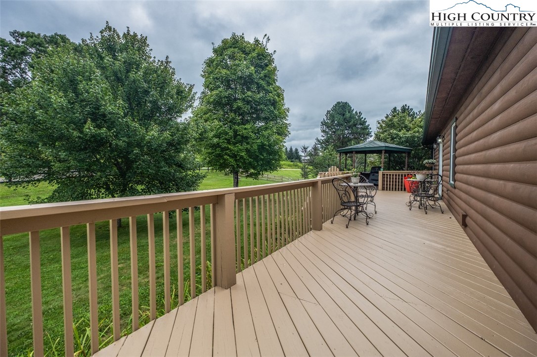 1453 Big Flatts Church Road Fleetwood, NC 28626 - Photo 14 of 50 a balcony with wooden floor table and chairs