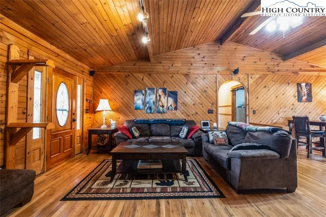 a dining room with furniture and wooden floor