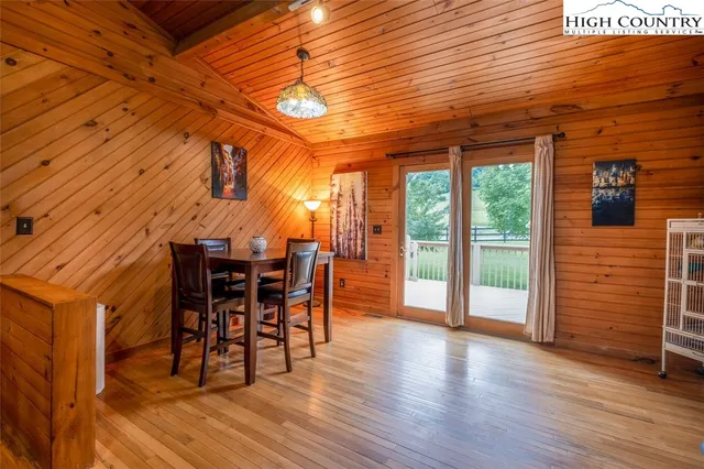a view of a room with wooden floor and furniture