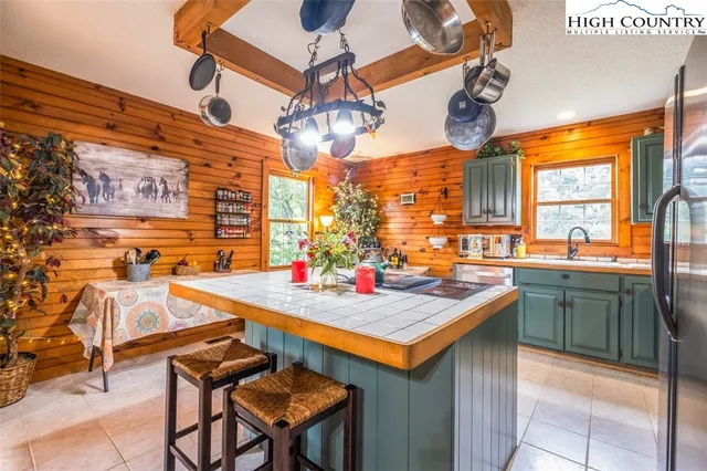 a living room with a bed next to a window with outer view