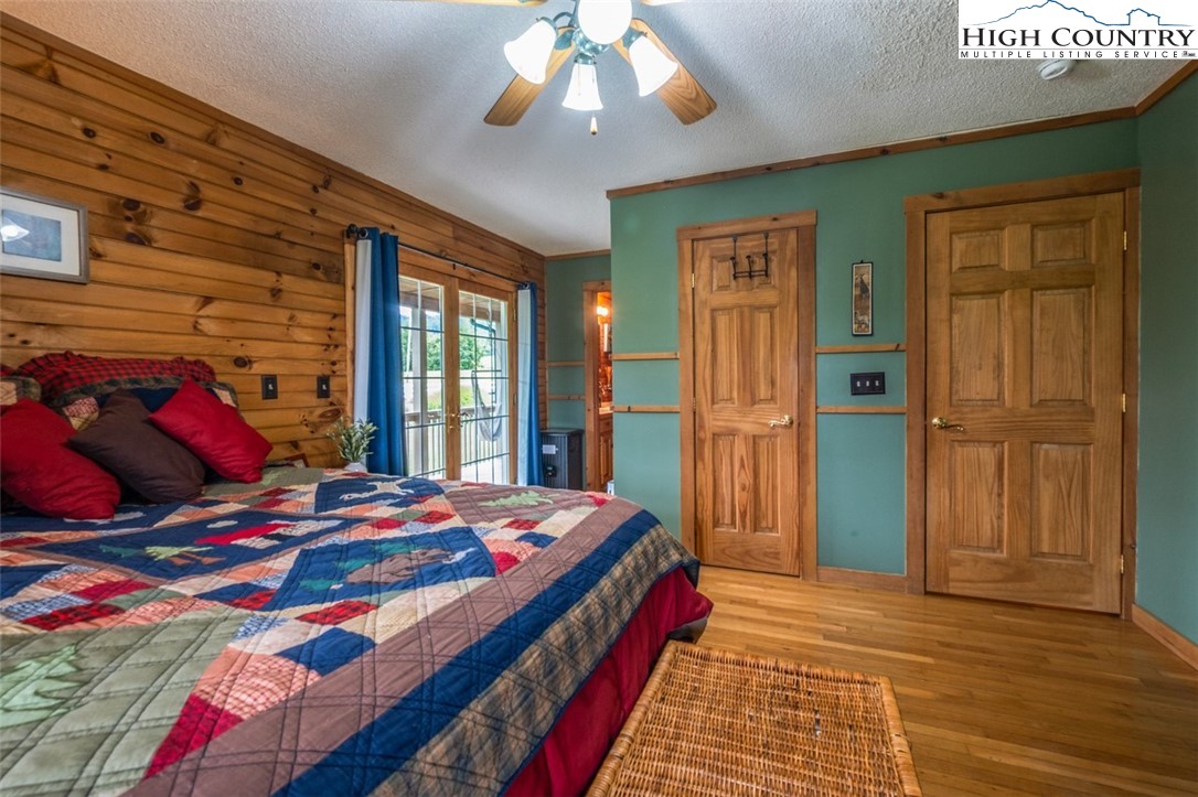 1453 Big Flatts Church Road Fleetwood, NC 28626 - Photo 25 of 50 a bedroom with a bed and a chandelier