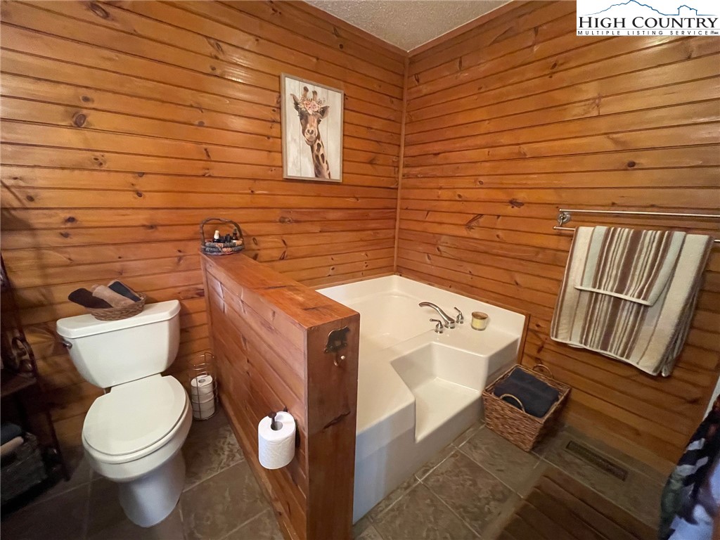 1453 Big Flatts Church Road Fleetwood, NC 28626 - Photo 27 of 50 a bathroom with a toilet and a sink