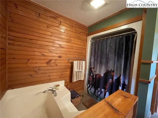 a bedroom with a bed next to a window with the outer view