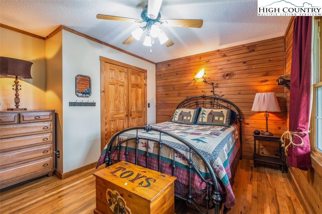 1453 Big Flatts Church Road Fleetwood, NC 28626 - Photo 29 of 50 a bedroom with a bed next to a window with the outer view