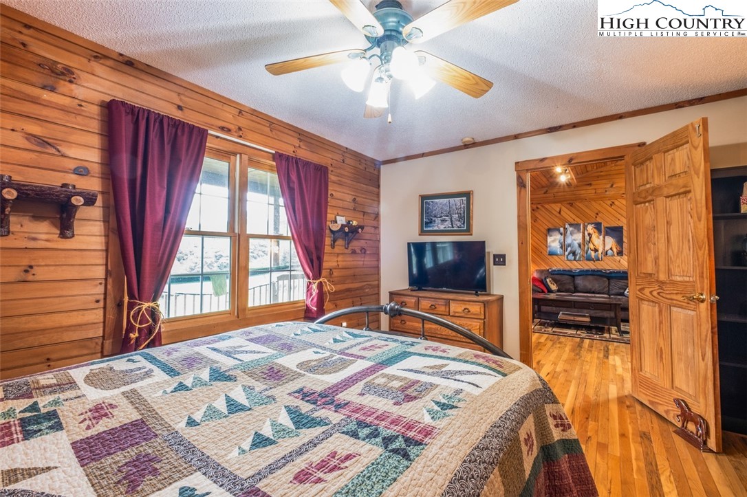 1453 Big Flatts Church Road Fleetwood, NC 28626 - Photo 30 of 50 a bedroom with a bed and a flat screen tv