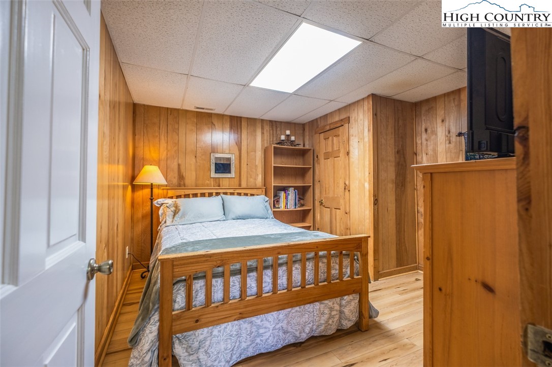 1453 Big Flatts Church Road Fleetwood, NC 28626 - Photo 36 of 50 a bedroom with a bed and wooden floor