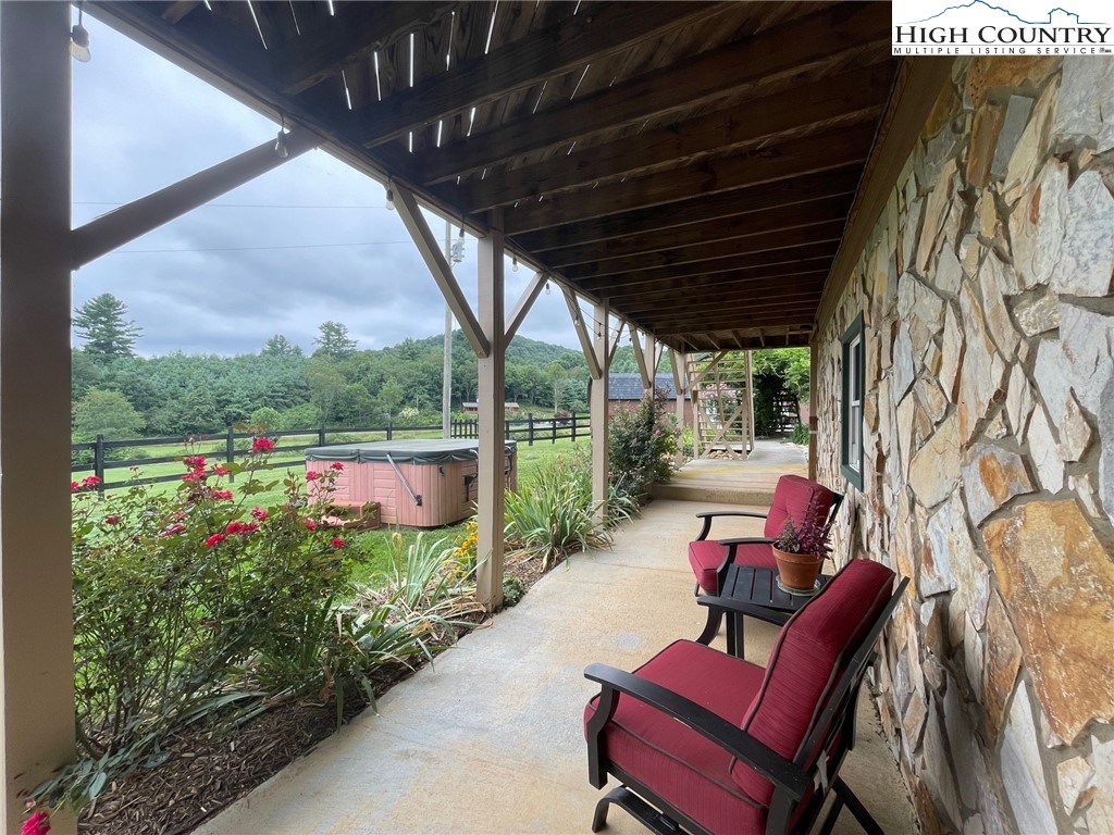 1453 Big Flatts Church Road Fleetwood, NC 28626 - Photo 41 of 50 a view of a porch with furniture and a yard