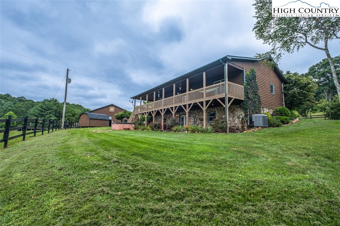 1453 Big Flatts Church Road Fleetwood, NC 28626 - Photo 5 of 50 a view of a house with a big yard and large trees