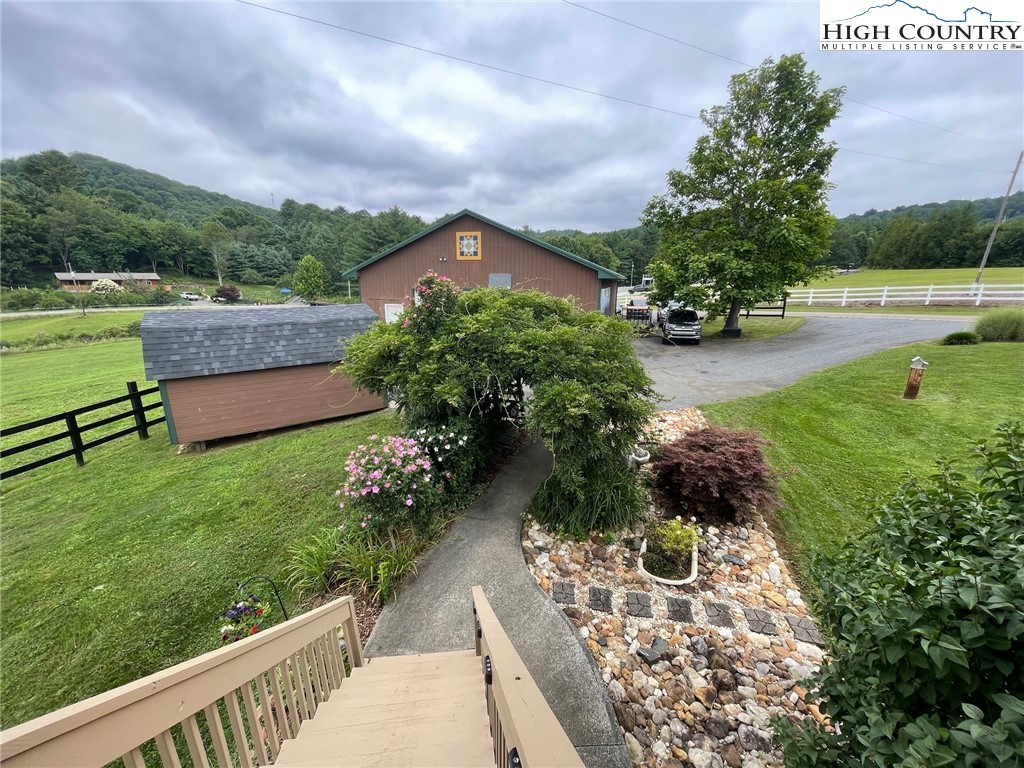 1453 Big Flatts Church Road Fleetwood, NC 28626 - Photo 8 of 50 a view of a garden with a bench in the garden