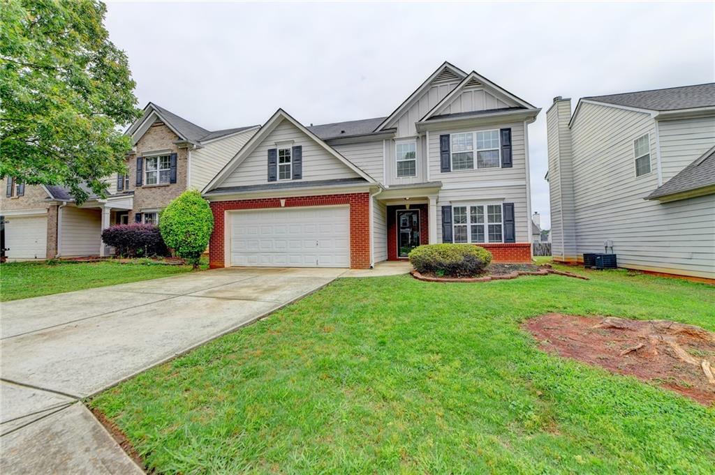2124 Pine View Trail Ellenwood, GA 30294 - Photo 1 of 1 a front view of a house with a yard and garage