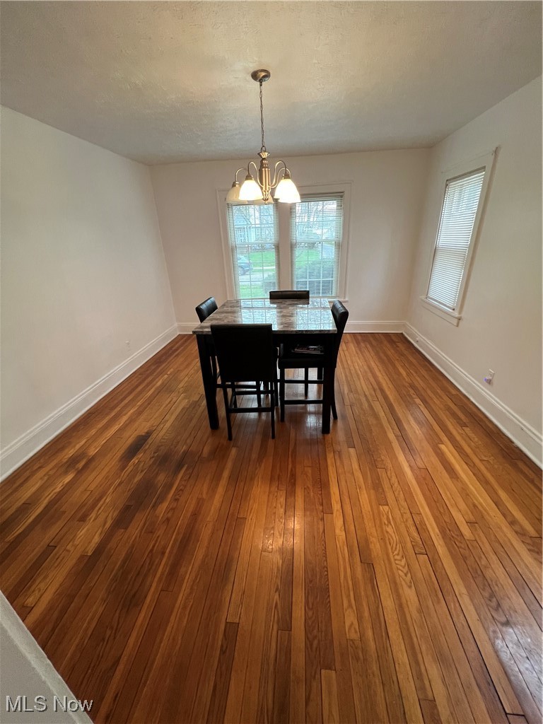 3362 Sutton Road Cleveland, OH 44120 - Photo 8 of 43 Dining area with a notable chandelier, dark wood finished floors, and baseboards