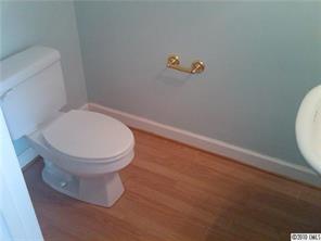 1355 North Dobys Bridge Road Fort Mill, SC 29715 - Photo 11 of 12 a bathroom with a toilet and a wooden floor