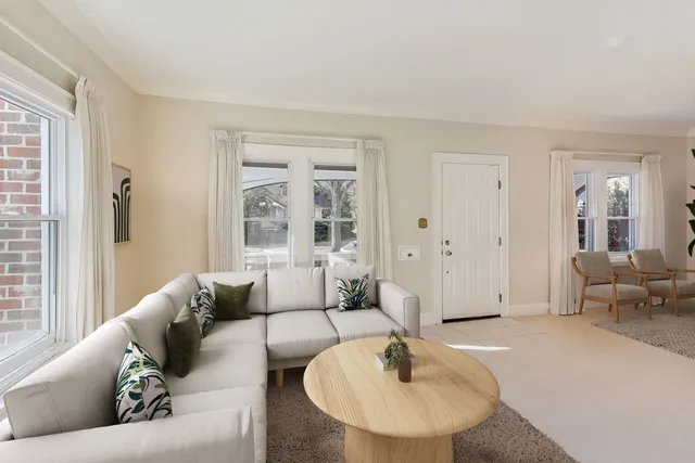 a living room with furniture rug and a window