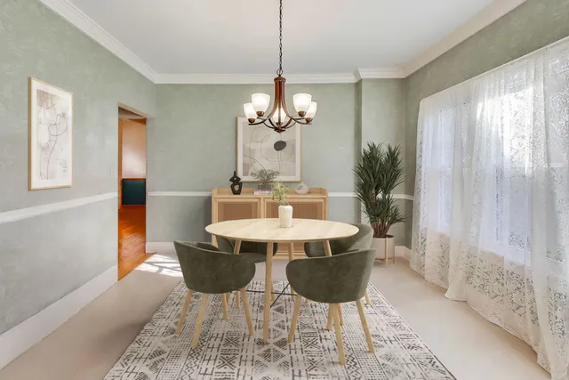 a living room with furniture and floor to ceiling windows