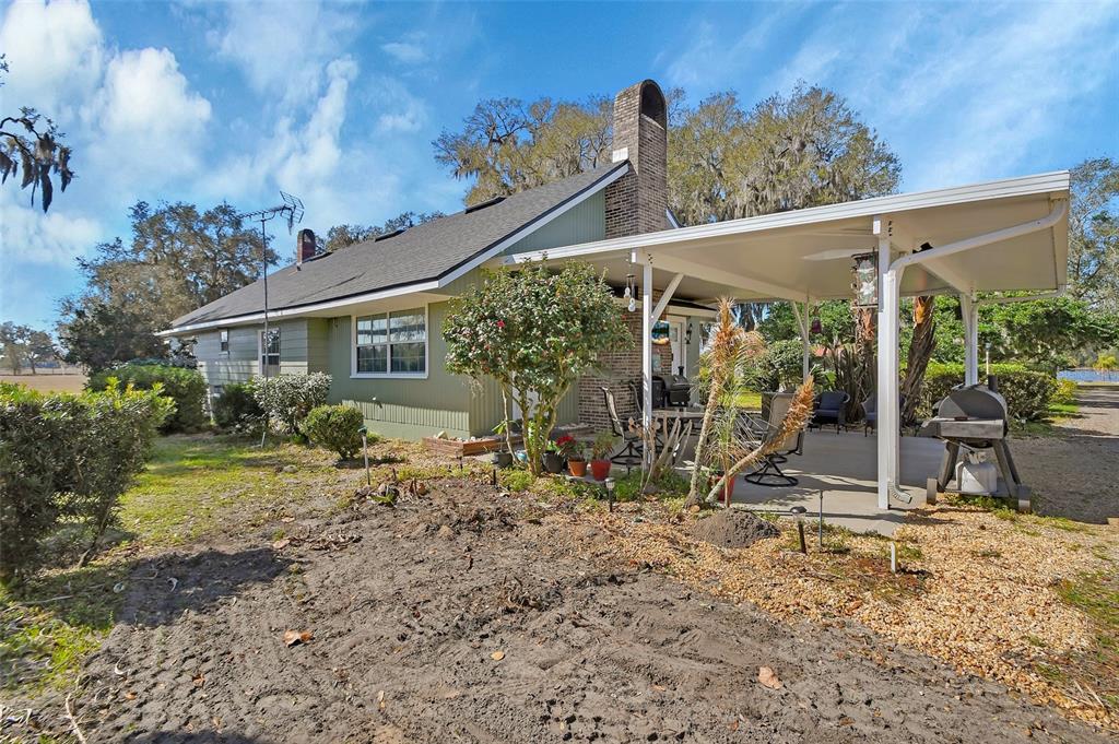 1403 Blackwelder Road De Leon Springs, FL 32130 - Photo 2 of 93 a view of a house with backyard and porch